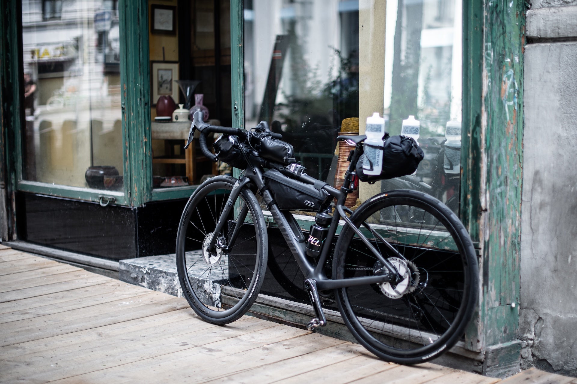 Musta retkipyörä nojaa lasiseinään